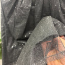 Détail du tulle noir transparent ponctué de fines paillettes et de sa finition au bas, jupe prototype n°029, taille S