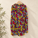 Prototype – Jupe longue à volant – Fleurs graphiques rouges et jaunes – S – N°055 — fond écru, cintre en bois et branches d’olivier